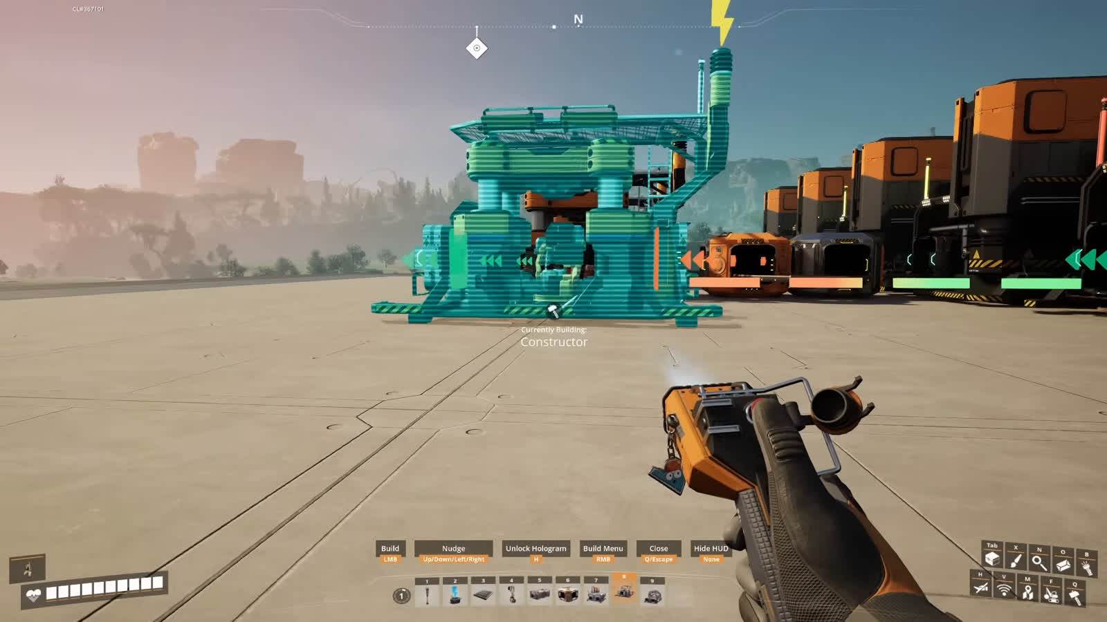 Satisfactory Constructor being placed next to a row of Foundries with a Currently Building tooltip visible