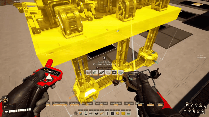 Satisfactory build gun placing a Constructor Manifold blueprint hologram onto a foundation
