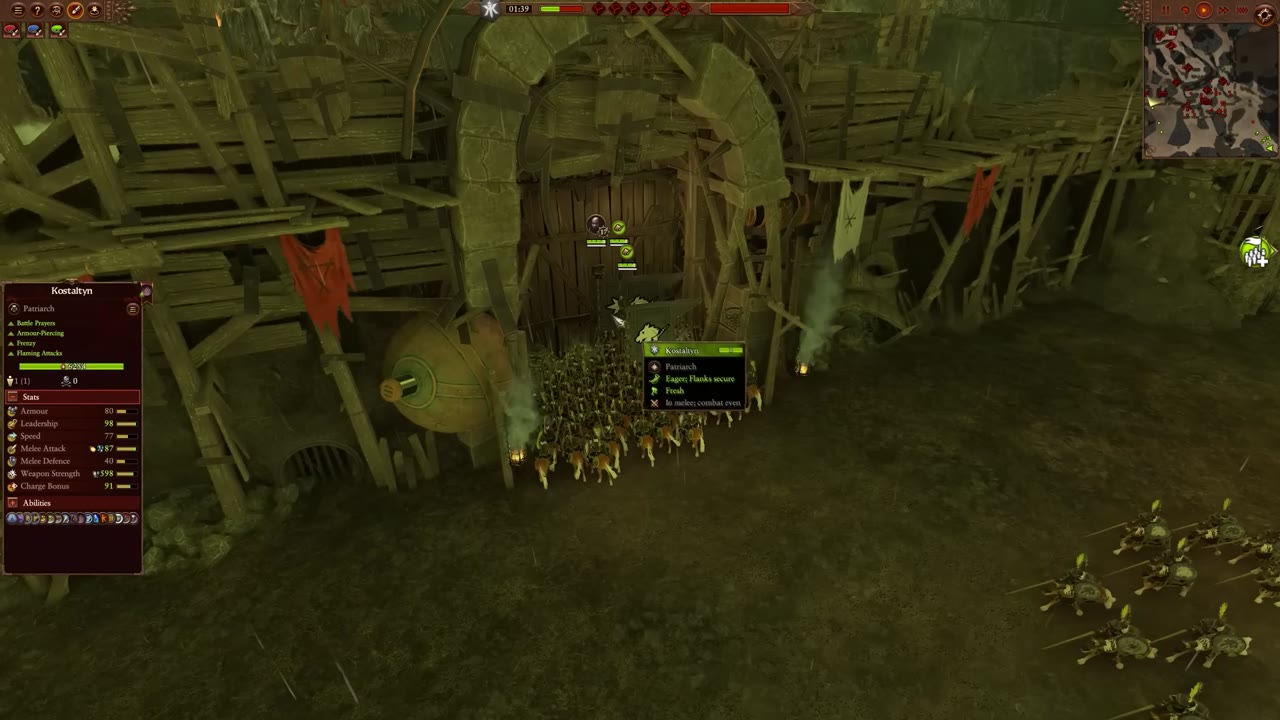 Units clustered in front of a settlement gate, with the gate blocking their path and character stats for Kostaltyn visible on the left.