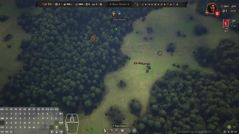 Game map view with a forest clearing; icons for a bandit camp, raider, and unit are visible, the cursor in the middle shows an active placement spot, and a keyboard overlay is shown bottom left.