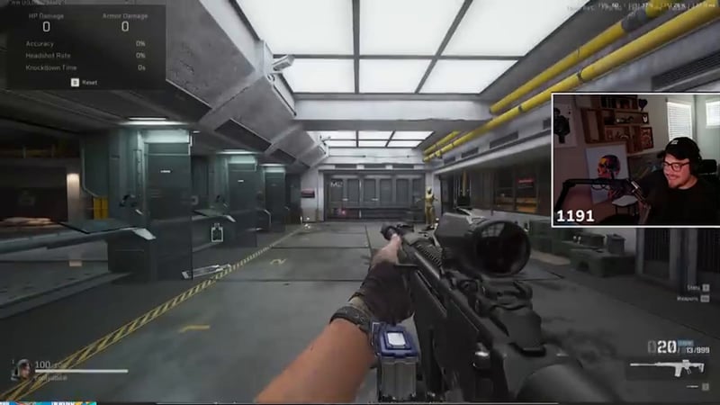 Delta Force firing range test showing a scoped rifle aimed down a long indoor corridor with an HP/Armor Damage stat panel in the top left