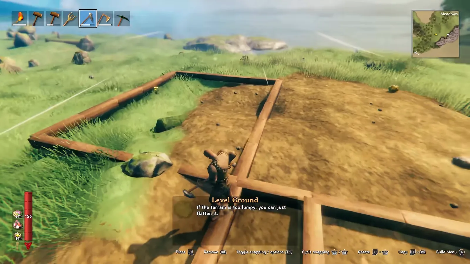 Valheim player leveling ground with the hoe while standing on a wooden floor frame