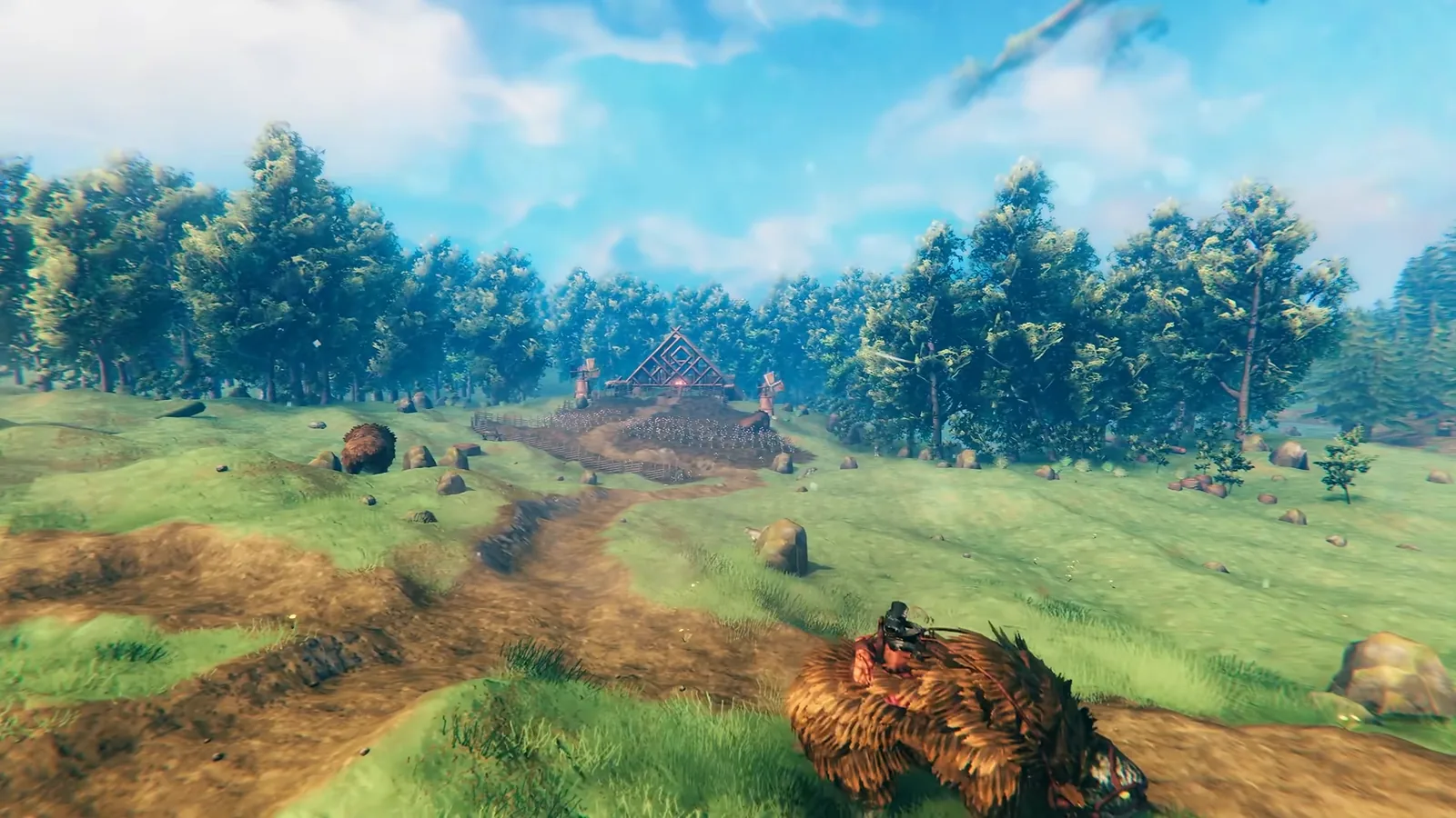Valheim dirt road leading across a meadow to a separate base building