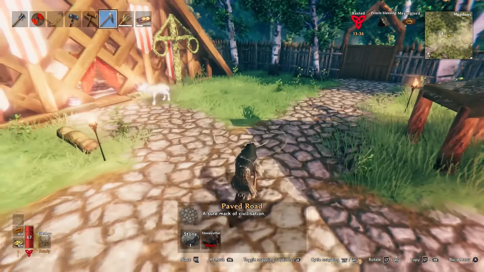 Valheim hoe Paved Road mode laying a cobblestone path between buildings